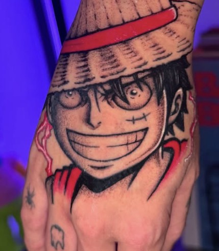 Anime character hand tattoo